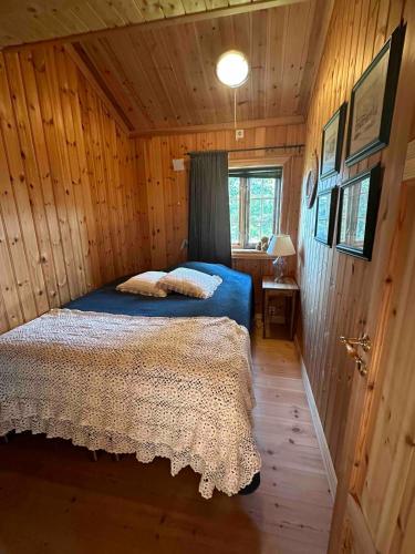 a bedroom with a bed in a wooden cabin at Trollslottet på Skeikampen in Aulstad