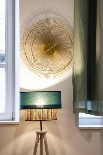 - un ventilateur de plafond et une lampe dans la chambre dans l'établissement L'Opéra 2 - RDC - Joli studio Hôtel de Ville, à Lyon