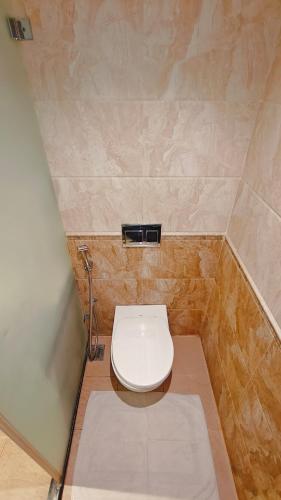 a bathroom with a toilet in the corner of a room at MM Legacy - A Bergamont Hotel, Kanchipuram in Kanchipuram