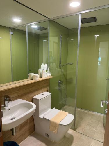 a bathroom with a toilet and a sink and a shower at vortex luxury apartment klcc in Kuala Lumpur
