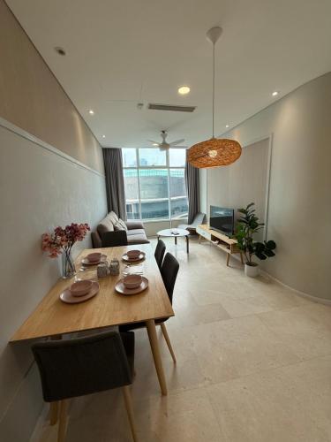 a dining room and living room with a table and chairs at vortex luxury apartment klcc in Kuala Lumpur