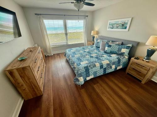 a bedroom with a bed and a window at Luxurious 67 Direct Oceanfront at Spanish Main in Cocoa Beach