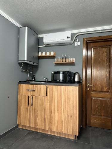 a kitchen with a sink and a microwave at Vila Miorita in Sebeş