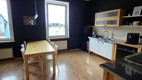 a kitchen with a table and a sink and a table and chairs at work & stay house in Linz in Linz am Rhein