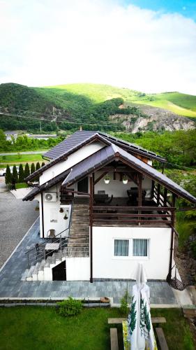 a large white house with a large deck at Vila Miorita in Sebeş