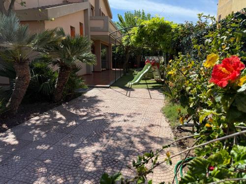 a garden with a playground and a slide at Sea Sweet Home - a due passi dal mare in Quartu SantʼElena