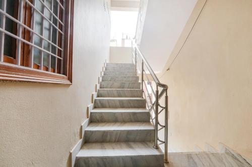 a staircase in an empty building with a window at Hotel Prestige Castle - Nr KIMS Hospital, Kondapur in Hyderabad