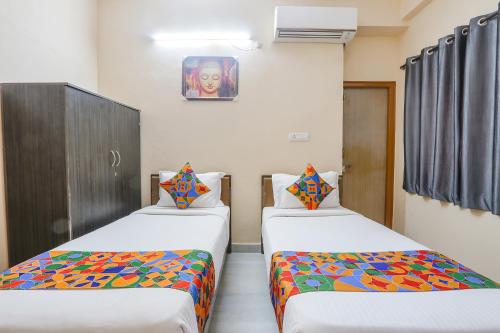 a room with two beds in a room at Hotel Prestige Castle - Nr KIMS Hospital, Kondapur in Hyderabad