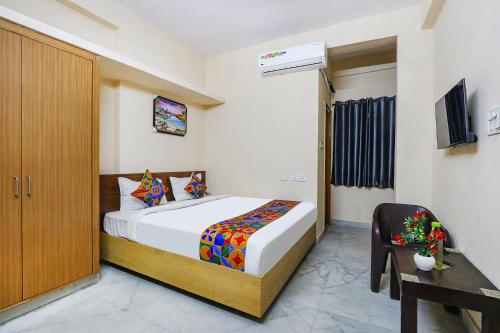 a bedroom with a bed and a cabinet and a table at Hotel Prestige Castle - Nr KIMS Hospital, Kondapur in Hyderabad