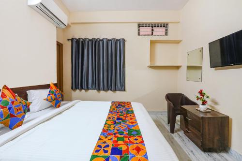 a hotel room with a bed and a tv at Hotel Prestige Castle - Nr KIMS Hospital, Kondapur in Hyderabad