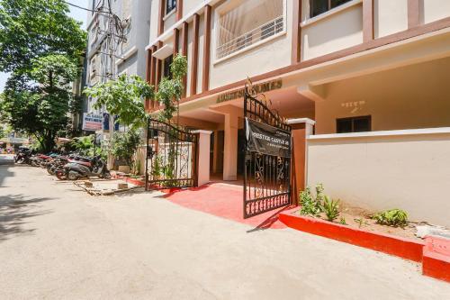 a building with a gate on the side of a street at Hotel Prestige Castle - Nr KIMS Hospital, Kondapur in Hyderabad