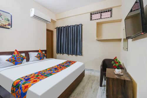 a hotel room with a bed and a tv at Hotel Prestige Castle - Nr KIMS Hospital, Kondapur in Hyderabad