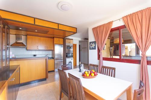 a kitchen with a table with a bowl of fruit on it at Granillo Escape in Costa Calma