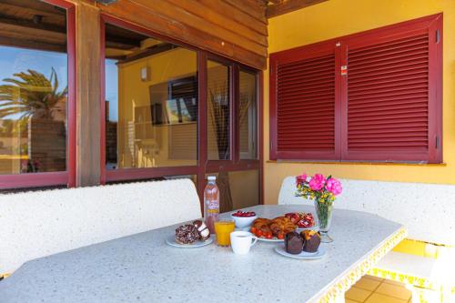 a table with food and flowers on a patio at Granillo Escape in Costa Calma