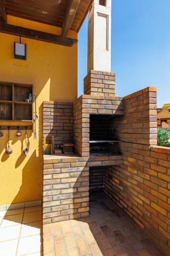an outdoor brick pizza oven on a patio at Granillo Escape in Costa Calma