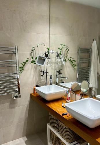 a bathroom with two sinks and a mirror at Eleven Views in Chipiona