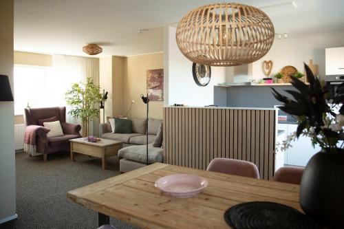 a living room with a couch and a table at Hello Zeeland - Appartement Weststraat 14 in Domburg