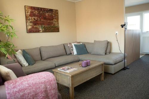a living room with a couch and a coffee table at Hello Zeeland - Appartement Weststraat 14 in Domburg