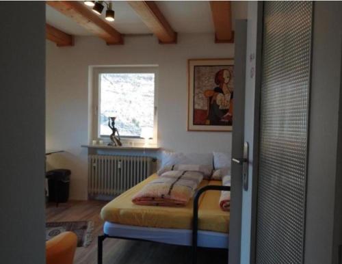 a bedroom with a bed in a room with a window at Ferienwohnung Thumseestraße 18 in Bad Reichenhall