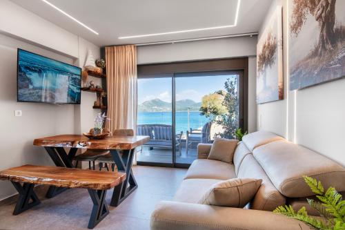 a living room with a couch and a table at September15 Suites, Lefkada-Episkopos in Nikiana