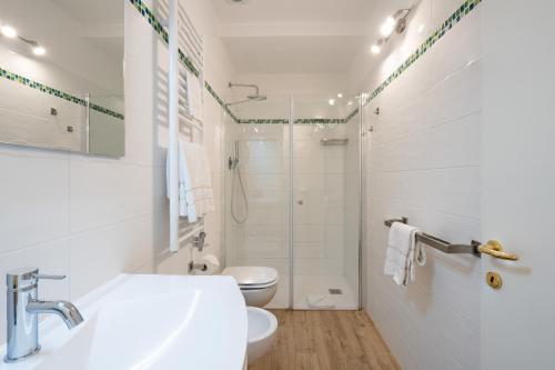 a white bathroom with a toilet and a sink at Rimon Residence in Venice
