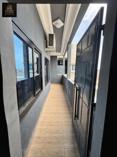 a hallway of an office building with a door and windows at SMART BÂTIPRO Appartement 2 chambres salon 2 in Cotonou