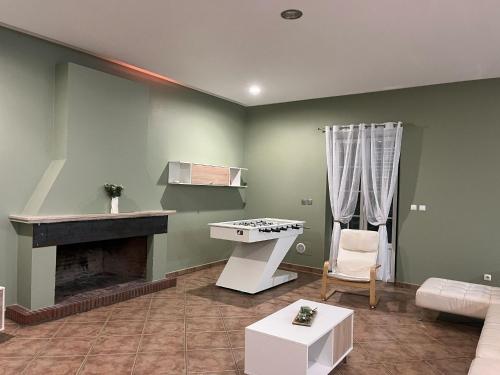 a living room with a fireplace and a couch at Monte do Carapetal in Amareleja