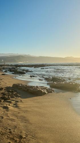 a beach with a body of water and the ocean at Chez Abel in Las Palmas de Gran Canaria