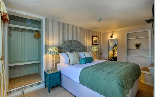 a bedroom with a large bed in a room at The Globe Inn in Wells next the Sea