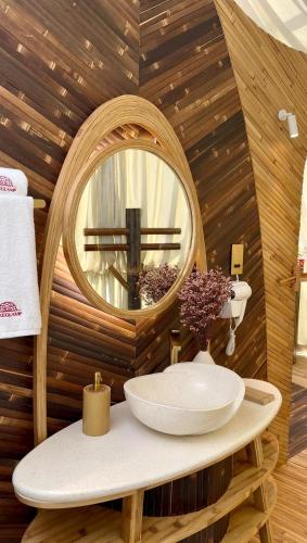 a bathroom with a sink and a mirror at Luxeglamp in Umm Al Quwain