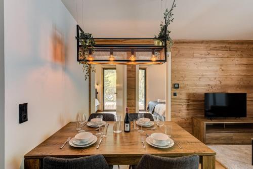 a dining room with a wooden table and chairs at Mazot de Kayla, Alpes Travel, Les Houches, Sleeps 4 in Les Houches