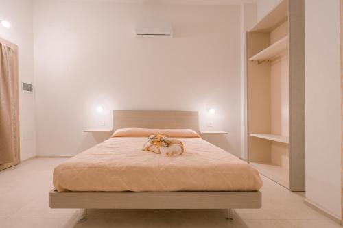 a bed with two dogs sitting on top of it at Affittacamere Avedí in Siniscola