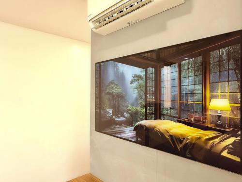 a bedroom with a window with a painting on the wall at Khách sạn Miami Ninh Thuận in Phan Rang