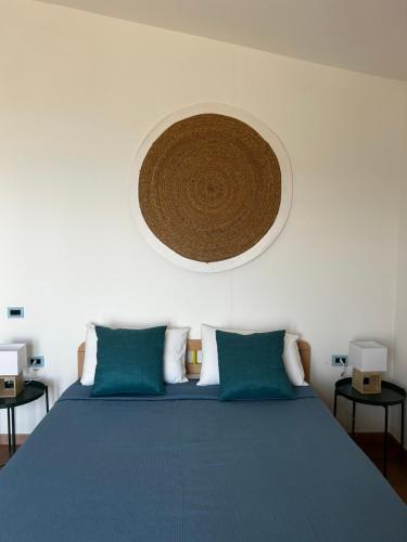 a bedroom with a large bed with blue sheets and a circular ceiling at Villa Monte Sacro - Manfredi Homes& Villas in Mattinata
