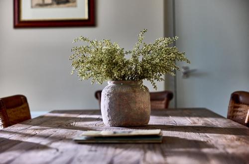 a vase with flowers sitting on a wooden table at The Globe Inn in Wells next the Sea
