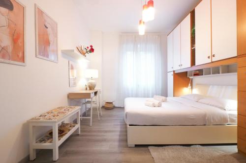 a bedroom with two beds and a desk in it at PrimoPiano - Padova 217A in Milan