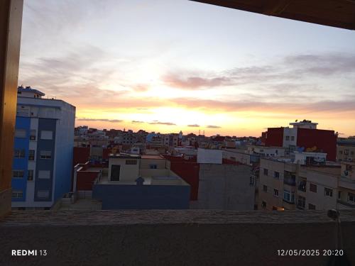 a view of a city skyline at sunset at À mi-chemin in Larache