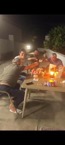 a group of men sitting around a table at THAT MAY Hotel in Yangshuo
