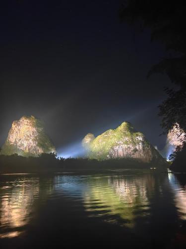 a group of rocks in the water at night at THAT MAY Hotel in Yangshuo
