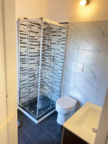 a bathroom with a shower and a toilet and a sink at Dream Stay Nettuno in Nettuno