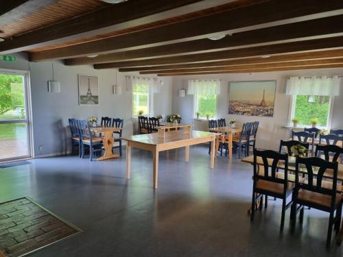 a dining room with wooden tables and chairs at Nyckelbo Vandrarhem in Helsingborg