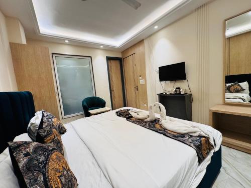 a hotel room with a bed and a television at Hotel 51 in Amritsar