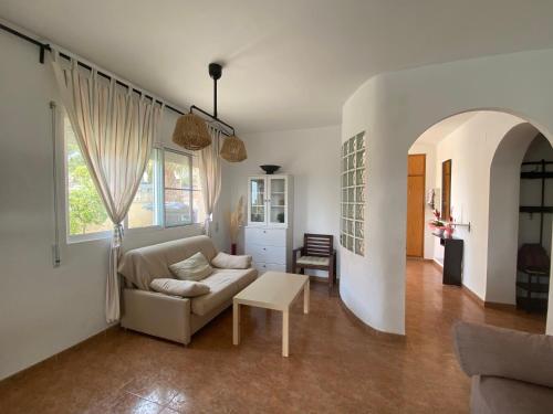 a living room with a couch and a table at Apartament Casa Bonfill in L'Ampolla