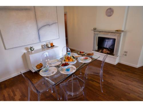 a table with plates of food on it with a fireplace at Timeless Garden Lake Como in Gravedona