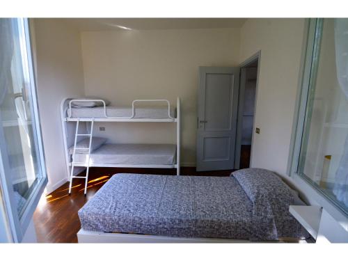 a bedroom with a bed and a bunk room with a ladder at Timeless Garden Lake Como in Gravedona