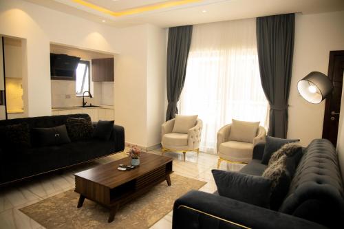 a living room with a couch and a table at AIDEN HOMES AND APARTMENTS HOTEl in Koforidua