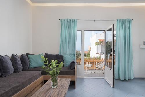 a living room with a couch and a table at Porfyra Suite 1 in Skala