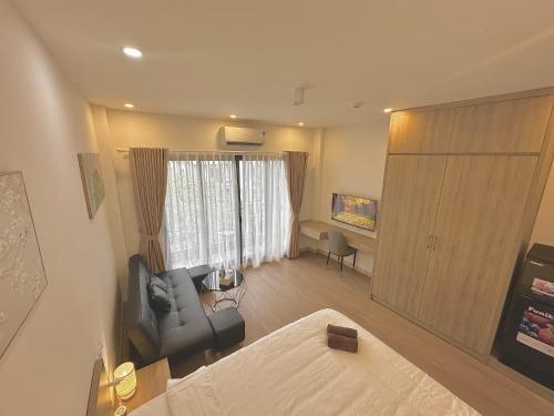 a living room with a couch and a chair at Happy Home - Big Balcony - Best Location in Hanoi