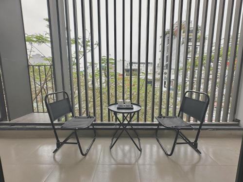two chairs and a table in front of a window at Happy Home - Big Balcony - Best Location in Hanoi