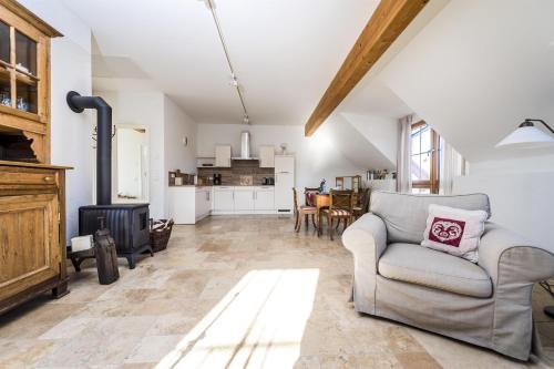 a living room with a couch and a stove at Hofgut Dösterhof - Ferienwohnungen in Wadern